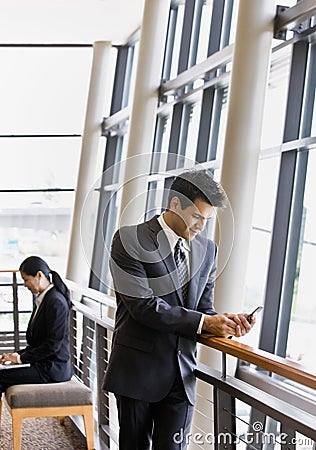 People working on laptop and text messaging Stock Photo