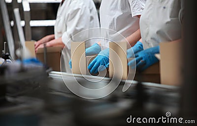 People working on packing line in factory - semi automation Stock Photo