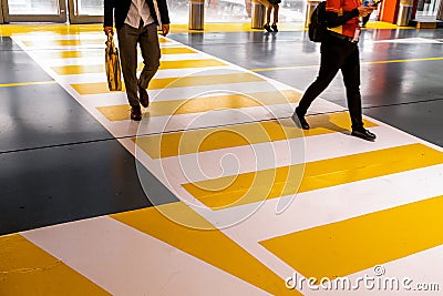 People at the zebra crossing underground Parking. Parking garage underground interior, pedestrian crossing, neon lights Stock Photo