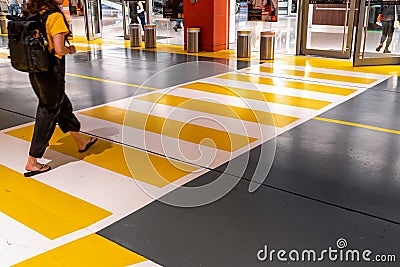 People at the zebra crossing underground Parking. Parking garage underground interior, pedestrian crossing, neon lights Stock Photo