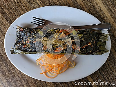 Pepes ikan bandeng is Indonesian traditional food, steam milkfish wrapped with banana leaf Stock Photo