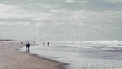 Peple walking on the sea shore Stock Photo