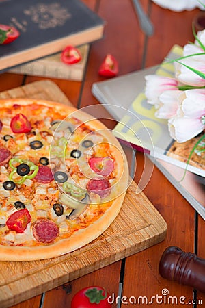 Pepperoni pizza with bell pepper, tomato slices, mushroom and olives. Stock Photo