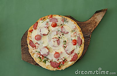 Pepperoni Pizza with Mozzarella cheese, sausages salami, Spices, tomato. Italian pizza on green background. Photo menu. Stock Photo