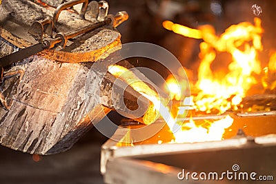 perator pouring molten metal in automatic casting line in foundry factory Stock Photo