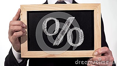 Percent sign drawn on blackboard in businessman hands, deposit interest rate Stock Photo