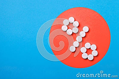 A percent sign of pills on a coral. Stock Photo