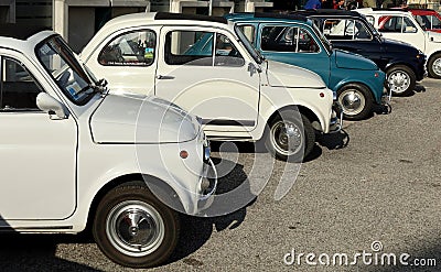 Row of white and blue vintage Fiat 500 at the roadside during a collector's car gathering. Editorial Stock Photo