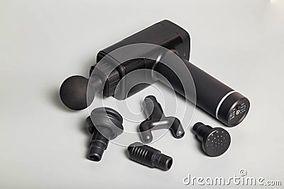 Percussion massager of deep muscle tissues for athletes, relaxes. Close up handheld wireless professional therapeutic shock Stock Photo