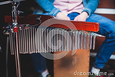Percussionist drummer performing on mark tree, selective focus and close-up view on professional bar chimes, drums accessories, Stock Photo