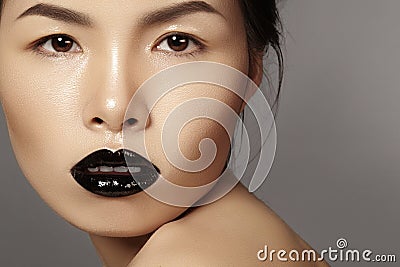 Close-up portrait asian model with fashion lips make-up, clean skin. Beauty halloween style with black lipstick makeup Stock Photo