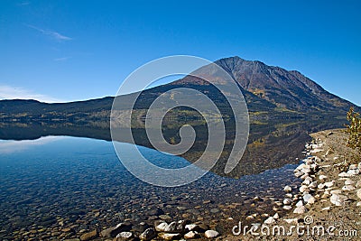 Perfect autumn reflection, Atlin Lake Stock Photo