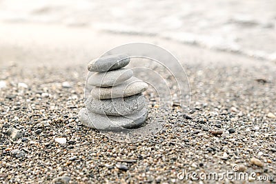 Perfect balance of stack of pebbles on the seashore. Concept of balance, harmony and meditation. Helping or supporting someone for Stock Photo