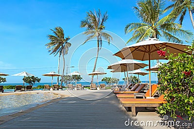 Perfect beach swimming pool with tropical resort relax. Stock Photo