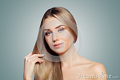 Perfect blonde woman showing her long healthy straight hair portrait. Hair care and hair straightening concept Stock Photo