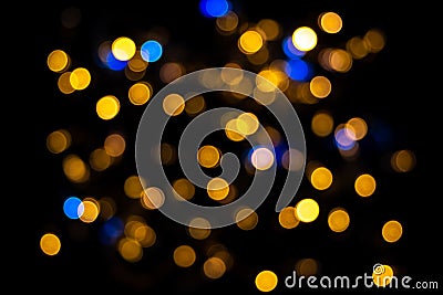 Perfect bokeh for a festive New Year and Christmas background. Defocused abstract yellow and blue light circles Stock Photo
