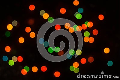 Perfect bokeh for a festive New Year and Christmas background. Defocused abstract yellow, green light circles. Stock Photo