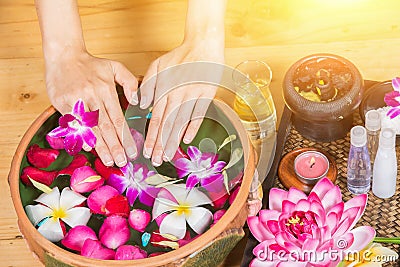 Perfect clean Asian female feet, Beautiful and elegant groomed girl`s hand touches her feet, Spa, Scrub and foot care Stock Photo