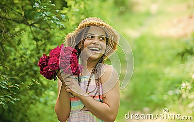 Perfect day. beautiful girl with flowers. little girl holding pink fresh blossoming flower bouquet of roses. flower Stock Photo