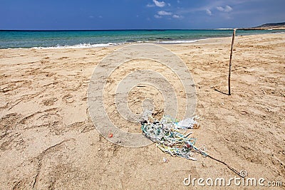 Perfect empty unspoiled beach, small pile of rubbish tangled pl Stock Photo