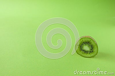 Perfect Fresh Green kiwi fruit Isolated on green Background Full Depth of Field Stock Photo