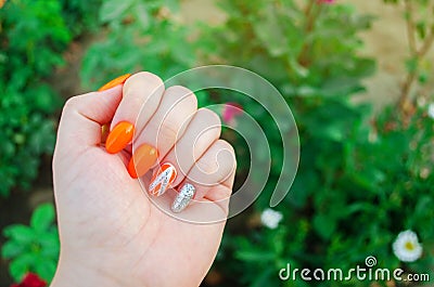 Perfect manicure and natural nails. Attractive modern nail art design. orange autumn design. long well-groomed nails Stock Photo