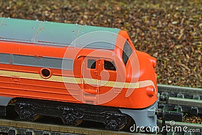 Perfect model of the orange diesel locomotive. Train hobby model on the model railway. Close-up Editorial Stock Photo