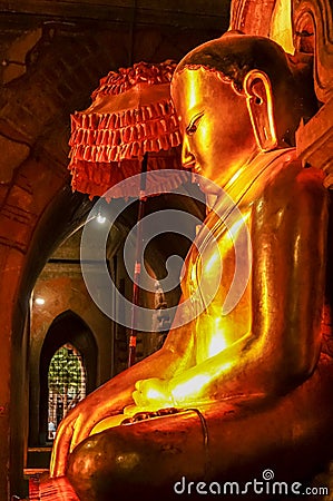 Perfect mystical buddha lit by late afternoon sun side view Stock Photo