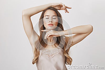 Perfect natural beauty of european model. Feminine good-looking woman wearing stylish outfit and makeup, framing face Stock Photo