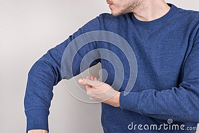 Perfect nice smell reliable deodorant concept. Cropped closeup photo of satisfied guy checking smell under arm grey Stock Photo