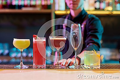 For the perfect nightlife. Classic cocktails, alcoholic drink on the bar counter with professional male bartender Stock Photo