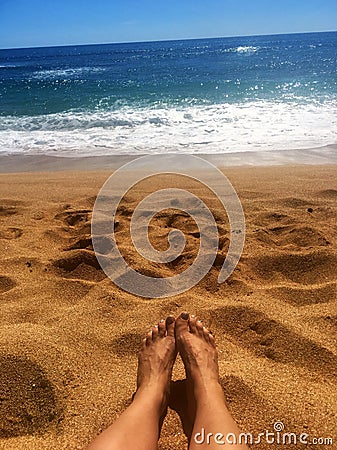 Perfect Paradise Feet up relaxing watching a glorious golden sunrise over the beach in Kauai Hawaii Stock Photo