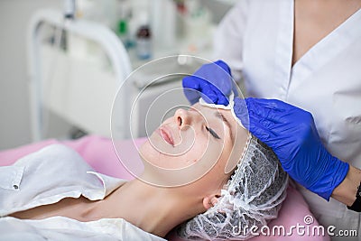 Perfect professional skin cleaning, spa treatment, face skincare. Hands of female doctor beautician in blue gloves Stock Photo