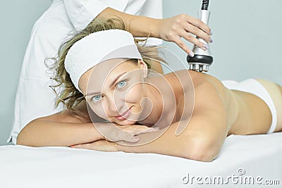 Perfect radio treatment. Woman at spa procedure. Doctor hand and girl body. RF cosmetology lifting. Back body Stock Photo