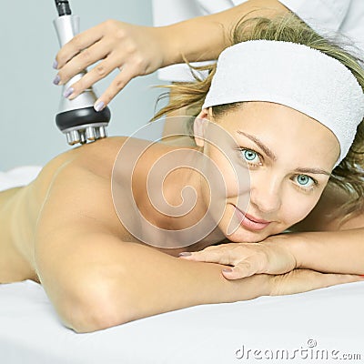 Perfect radio treatment. Woman at spa procedure. Doctor hand and girl body. RF Stock Photo