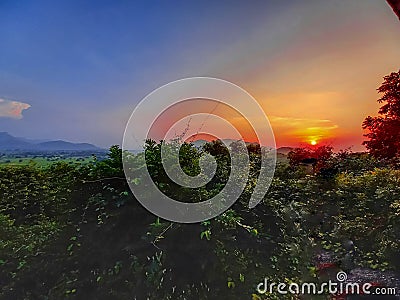 A perfect reddish sunset view with a beautiful scenery. Stock Photo