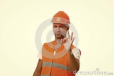 Perfect repairing guaranteed. man in helmet show ok gesture. successful worker in hardhat. wear hard hat to protect Stock Photo