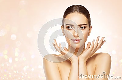 Perfect Skin Face Woman Portrait. Beauty Model with open Hands under Chin over Bright Shining Beige Background. Skin Care Cosmetic Stock Photo