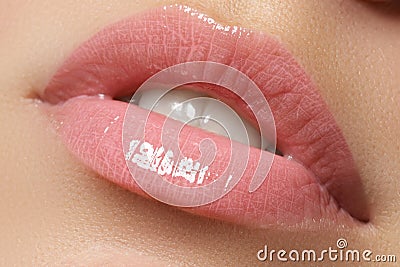 Perfect smile. Beautiful full pink lips and white teeth. Pink lipstick. Gloss lips. Make-up & Cosmetics Stock Photo