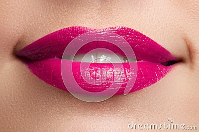 Perfect smile. Beautiful full pink lips and white teeth. Pink lipstick. Gloss lips. Make-up & Cosmetics Stock Photo