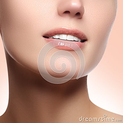 Perfect smile with white healthy teeth and natural full lips, dental care concept. Beautiful young woman's face fragment Stock Photo