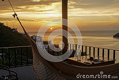 Perfect Sunset over the Caribbean Sea from the balcony with a hammock in the touristic village of Taganga near Santa Marta, 2020 Stock Photo