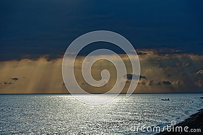 Perfect sunset on the sea, with radiant rays of sun over a warm colourful horizont. Stock Photo