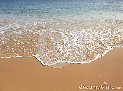 The perfect wave touches the perfect sand Stock Photo