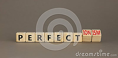 Perfectionism symbol. Concept words Perfect or Perfectionism beautiful wooden blocks. Beautiful grey table grey background. Stock Photo