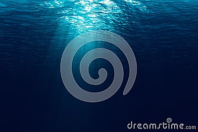 Perfectly seamless of deep blue ocean waves from underwater background with micro particles flowing, light rays shining through Stock Photo