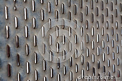 Perforated sheet of iron with oval oblong holes Stock Photo