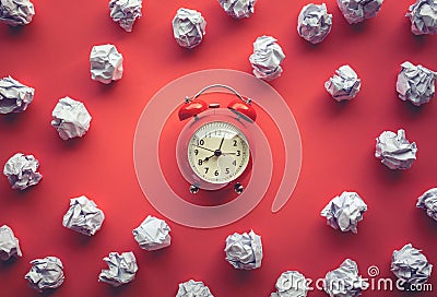 Performance concepts with paper crumpled ball and alarm clock on worktable background.Time and dateline Stock Photo