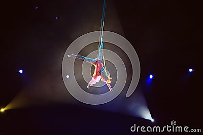 Performance of the girl aerial acrobat in the circus. Stock Photo