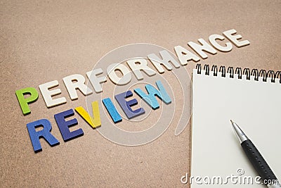Performance review text with open spiral notebook and pen Stock Photo